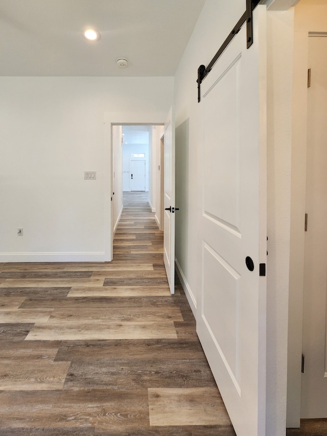 hallway featuring hardwood / wood-style flooring and a barn door