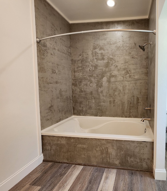 bathroom featuring wood-type flooring and tiled shower / bath combo