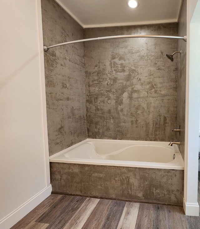 bathroom featuring tiled shower / bath and wood-type flooring