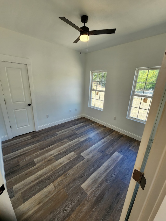 unfurnished room with ceiling fan and dark hardwood / wood-style floors