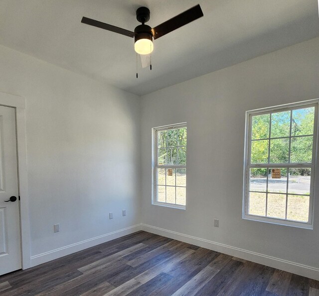 spare room with ceiling fan and dark wood-type flooring