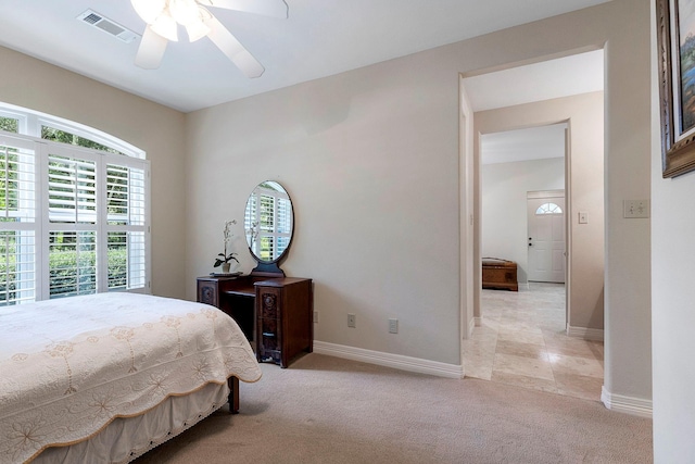 bedroom with ceiling fan and light colored carpet