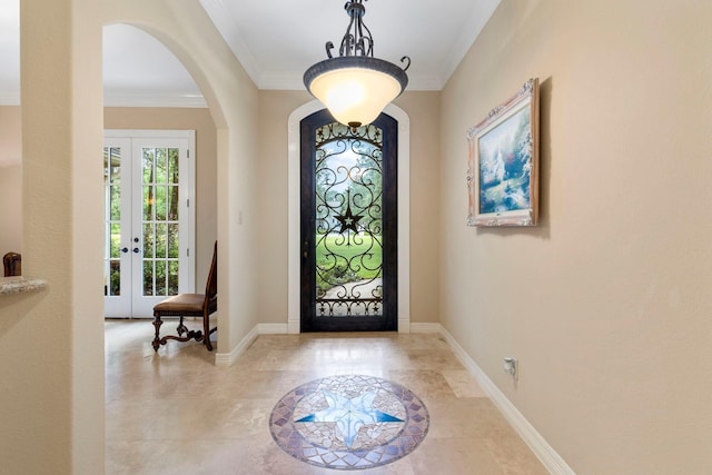 entrance foyer featuring crown molding and french doors