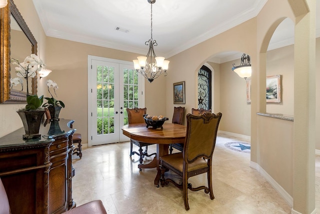 dining room featuring french doors, ornamental molding, and a notable chandelier