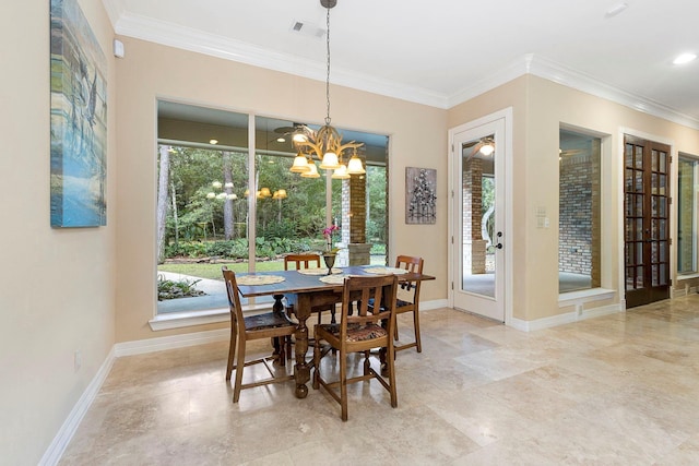 dining area featuring a wealth of natural light, crown molding, and an inviting chandelier