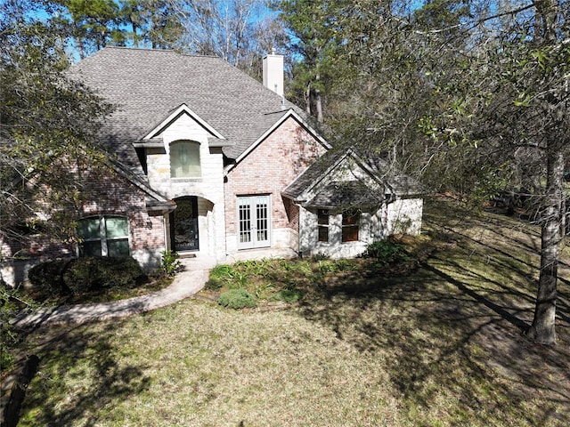 view of front facade featuring a front yard and french doors