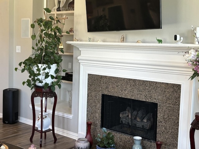 interior details with a fireplace and wood-type flooring