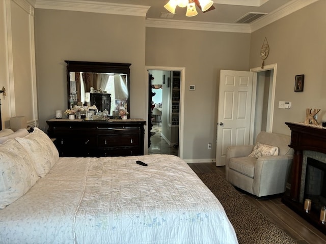 bedroom with ornamental molding, dark hardwood / wood-style flooring, and ceiling fan