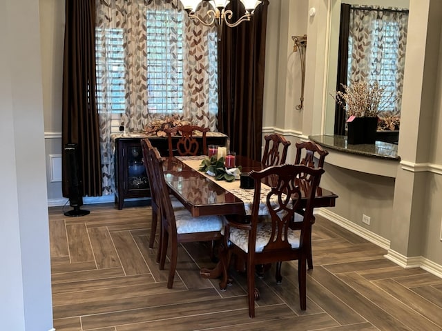 dining space featuring a chandelier and dark parquet floors