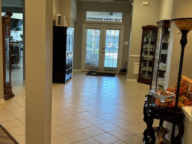 entryway with french doors, ceiling fan, and light tile patterned floors