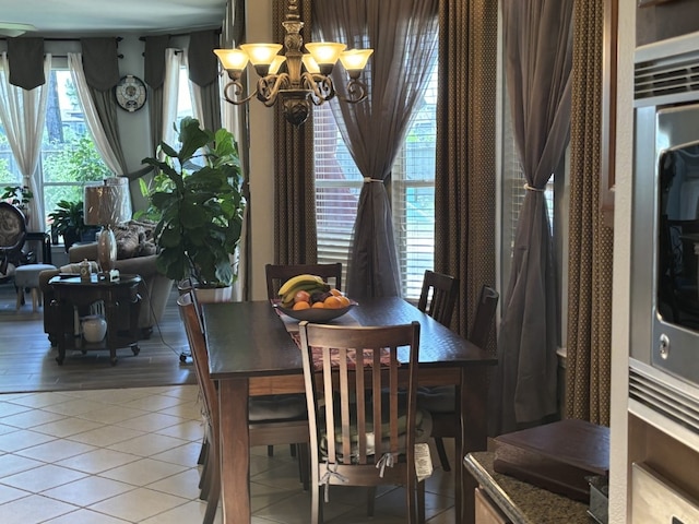 dining space featuring an inviting chandelier and tile patterned floors