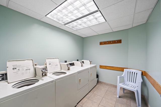 laundry room featuring light tile patterned floors and washer and clothes dryer