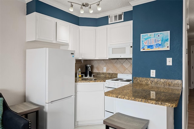 kitchen featuring backsplash, white appliances, crown molding, dark stone countertops, and white cabinetry