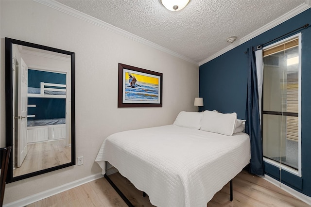 bedroom with hardwood / wood-style flooring, crown molding, and a textured ceiling