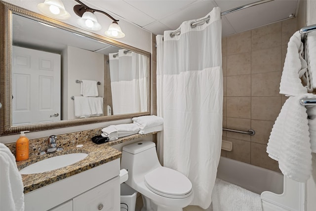 full bathroom with shower / bath combination with curtain, vanity, toilet, and a drop ceiling