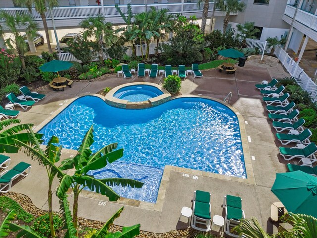 view of pool featuring a patio and a hot tub