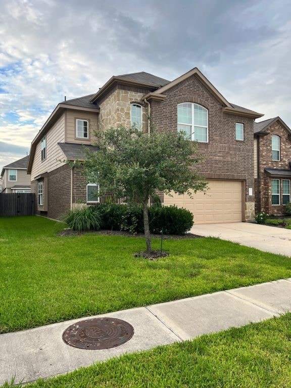 view of front of property featuring a garage and a front lawn