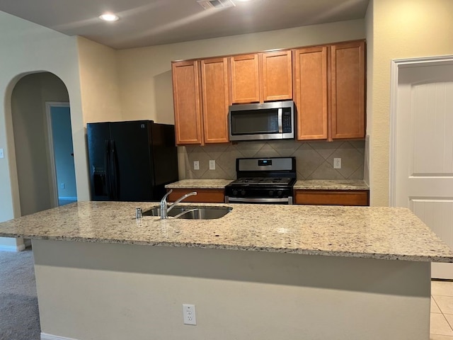 kitchen featuring appliances with stainless steel finishes, backsplash, light colored carpet, and sink