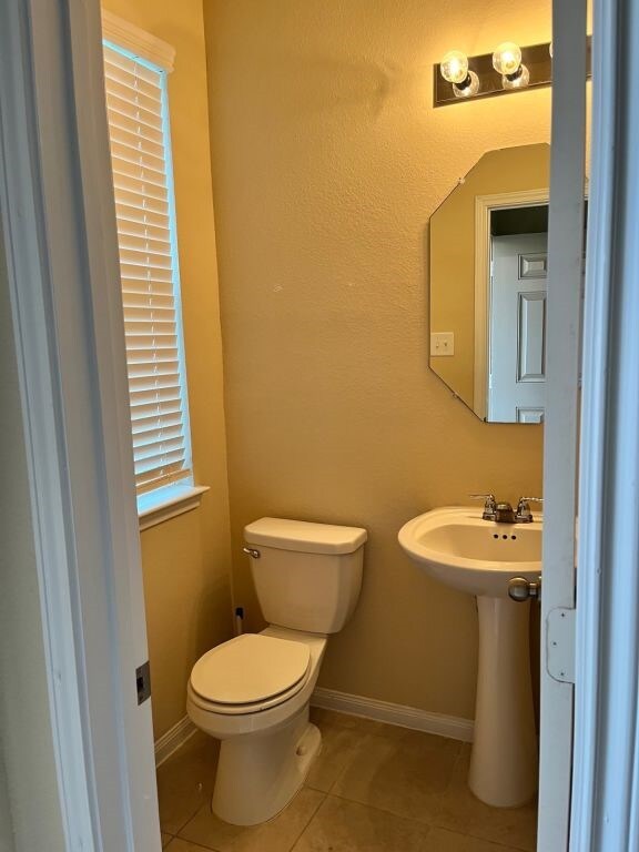 bathroom with tile patterned floors and toilet