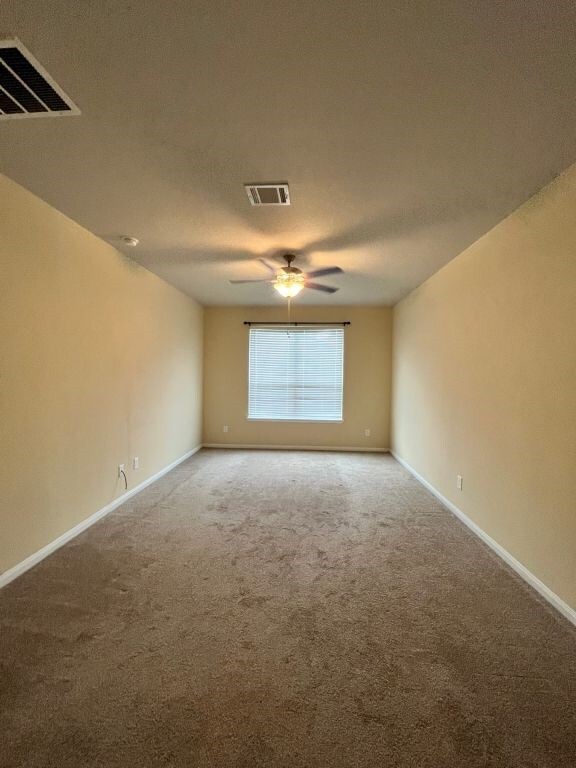 carpeted empty room with ceiling fan