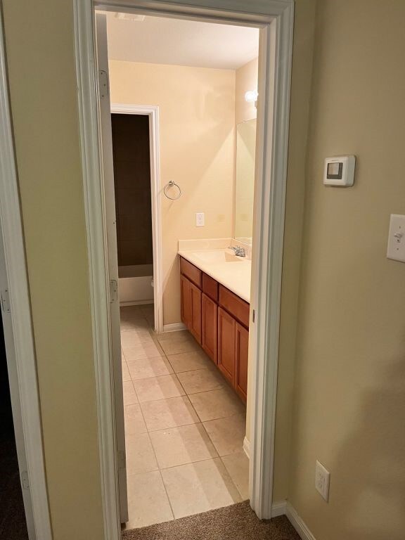 bathroom featuring tile patterned flooring and vanity