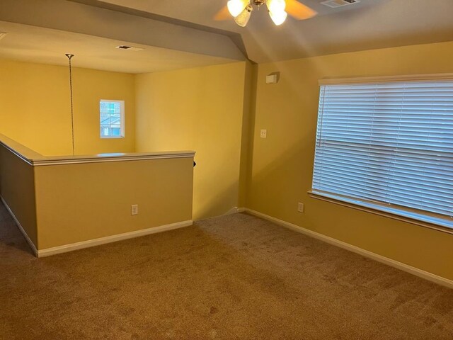 carpeted empty room featuring ceiling fan