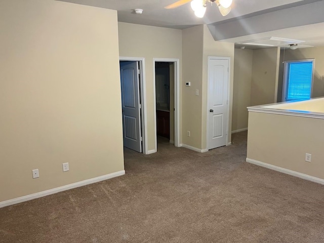 unfurnished room featuring ceiling fan and dark carpet