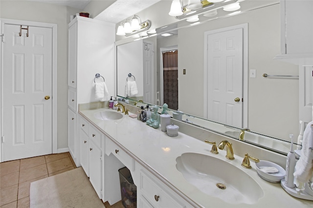 bathroom featuring tile patterned floors and dual bowl vanity