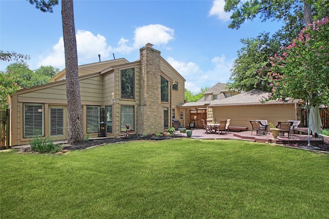 back of property featuring a patio area and a yard