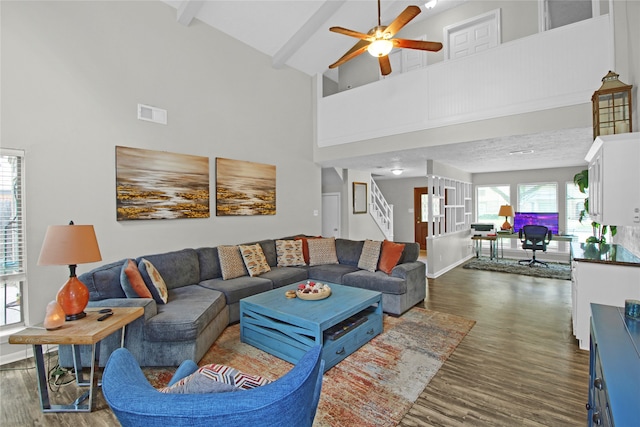 living room featuring high vaulted ceiling and dark wood-type flooring