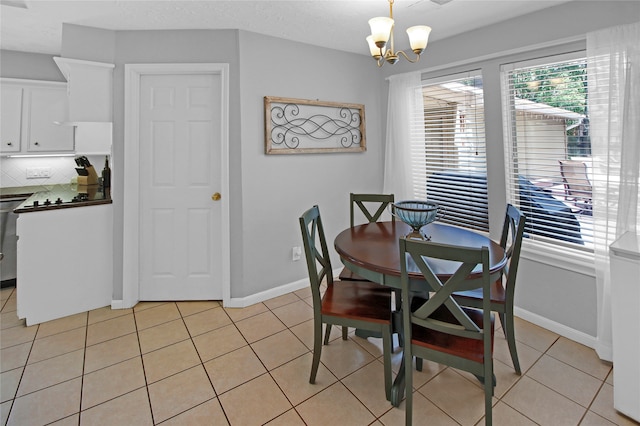 dining space featuring a notable chandelier and light tile patterned floors