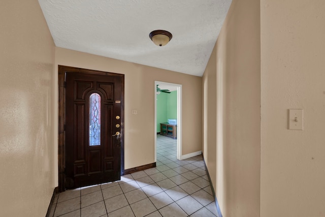 tiled entrance foyer with a textured ceiling