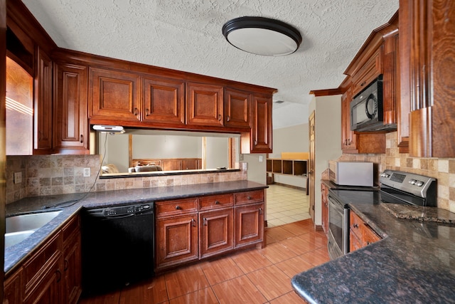 kitchen featuring backsplash, a textured ceiling, black appliances, and light tile patterned floors