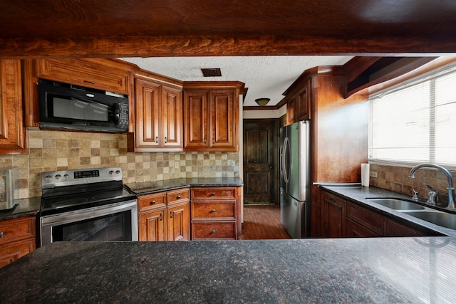 kitchen featuring hardwood / wood-style floors, decorative backsplash, stainless steel appliances, and sink