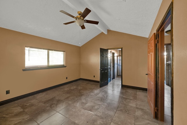 spare room with vaulted ceiling with beams, a textured ceiling, and ceiling fan