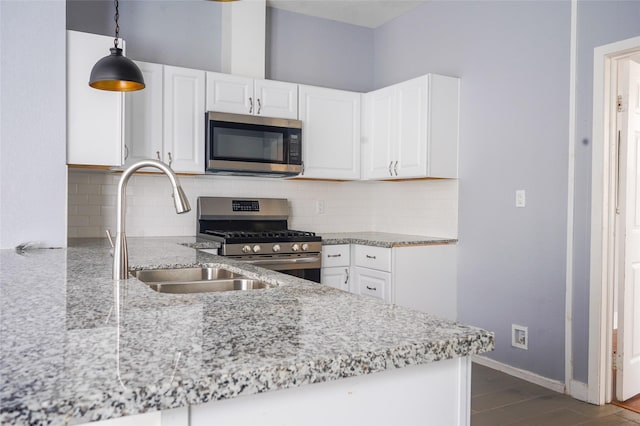 kitchen featuring a sink, white cabinetry, appliances with stainless steel finishes, and tasteful backsplash