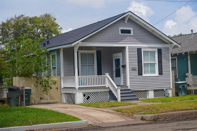 bungalow-style home featuring a porch and fence
