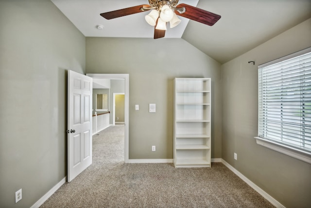 unfurnished bedroom with vaulted ceiling, ceiling fan, and carpet flooring