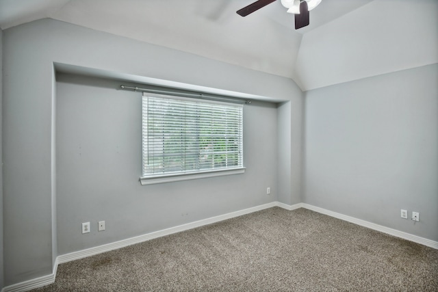 empty room with dark colored carpet, ceiling fan, and lofted ceiling