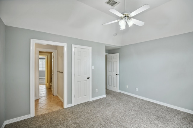 unfurnished bedroom featuring light colored carpet and ceiling fan