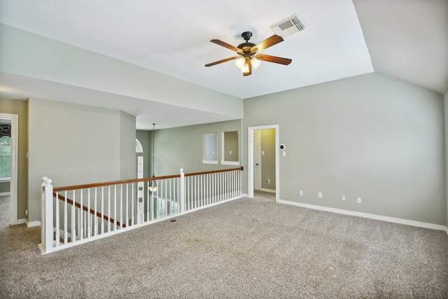 carpeted spare room with lofted ceiling and ceiling fan