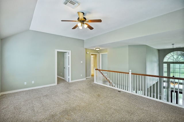 carpeted empty room with ceiling fan and lofted ceiling