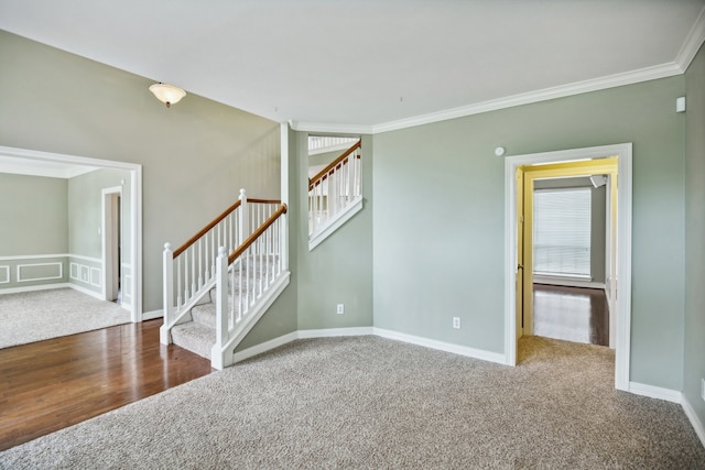 spare room featuring a wealth of natural light, crown molding, and dark hardwood / wood-style floors