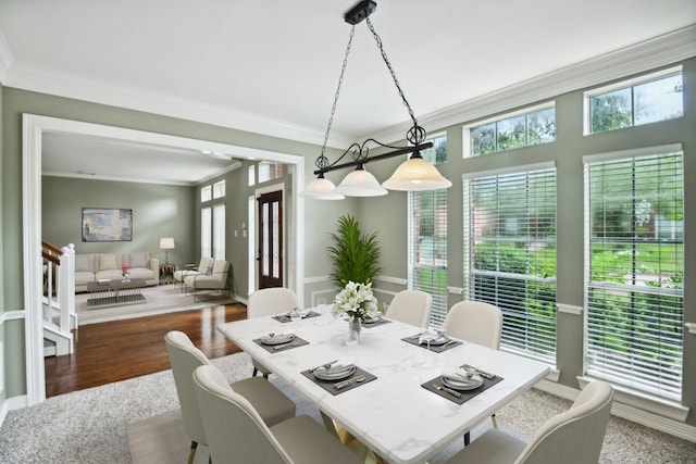 dining room with ornamental molding and hardwood / wood-style floors