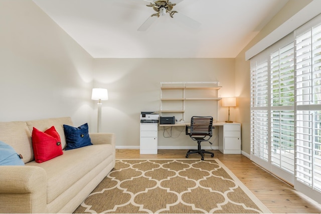 home office featuring ceiling fan and light hardwood / wood-style flooring