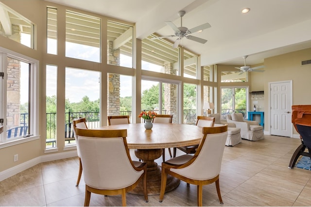 dining room with beam ceiling, light tile patterned floors, and high vaulted ceiling