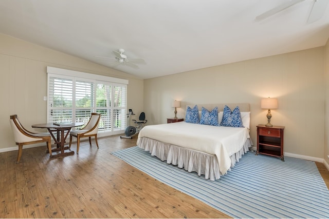 bedroom with lofted ceiling, hardwood / wood-style flooring, and ceiling fan