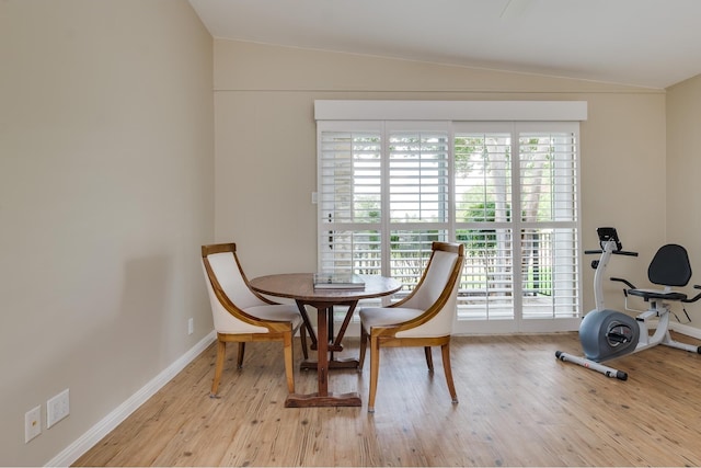 living area with light hardwood / wood-style flooring and vaulted ceiling