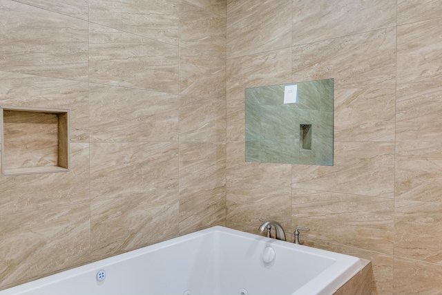 bathroom featuring a bathtub and tile walls