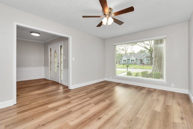 spare room featuring ceiling fan, light hardwood / wood-style flooring, and ornamental molding